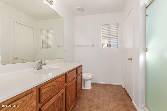 bathroom with tile patterned floors, vanity, and toilet