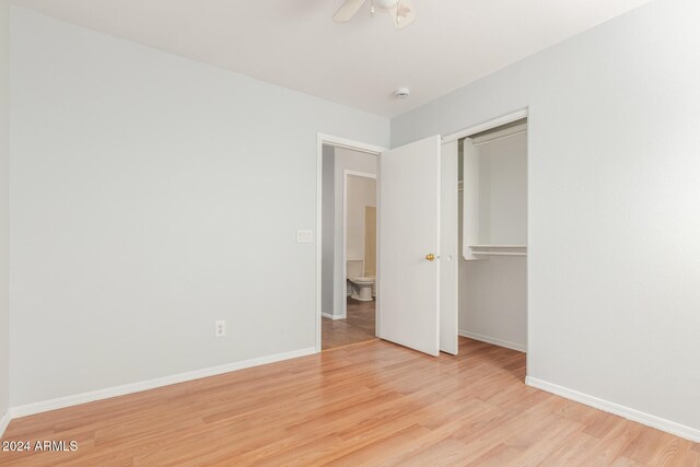 unfurnished bedroom featuring light hardwood / wood-style floors, a closet, and ceiling fan