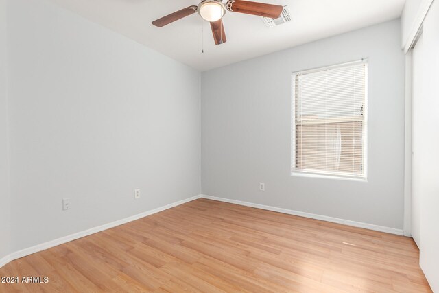 unfurnished room with ceiling fan and light wood-type flooring