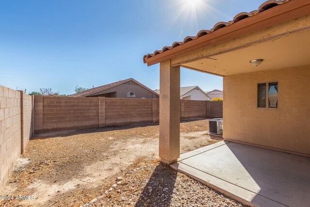 view of yard with a patio and central AC unit