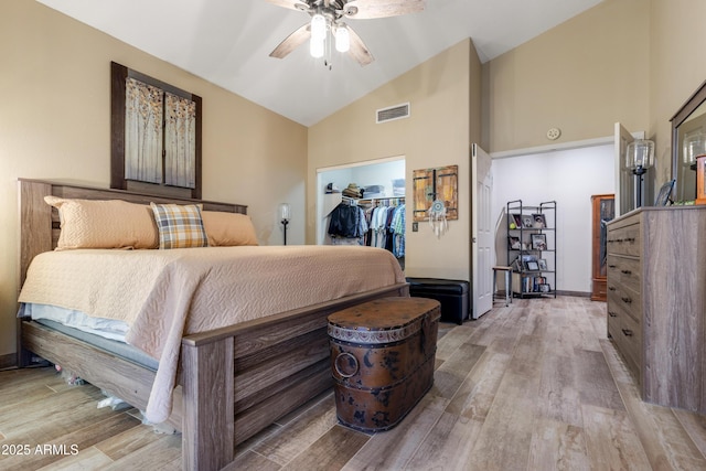 1437 E Glenhaven Dr, Phoenix, AZ 85048 - bedroom with wood finished floors, a walk in closet, high vaulted ceiling, a closet, and ceiling fan