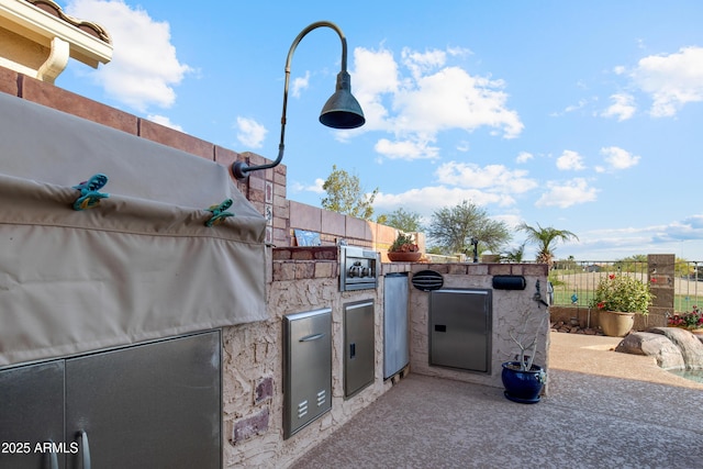1437 E Glenhaven Dr, Phoenix, AZ 85048 - view of patio with exterior kitchen and fence