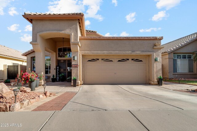1437 E Glenhaven Dr, Phoenix, AZ 85048 - mediterranean / spanish-style house with driveway, stucco siding, an attached garage, and a tiled roof