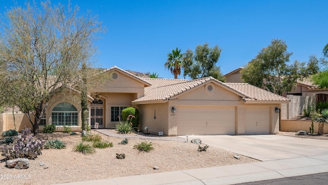 116 E Mountain Sky Ave, Phoenix, AZ 85048 - view of front of house featuring an attached garage, stucco siding, driveway, and a tiled roof