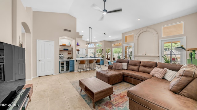 116 E Mountain Sky Ave, Phoenix, AZ 85048 - living room with beverage cooler, ceiling fan, light tile patterned flooring, high vaulted ceiling, and arched walkways