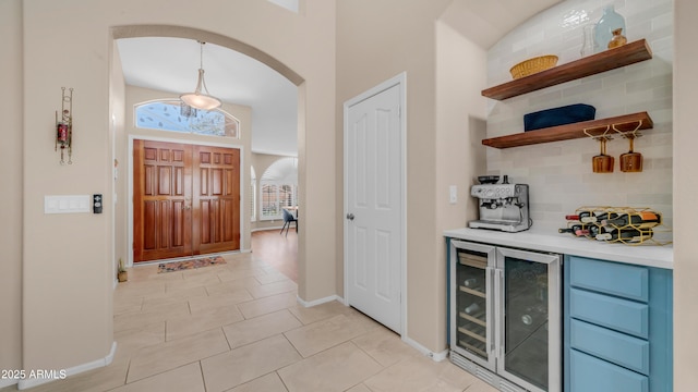 116 E Mountain Sky Ave, Phoenix, AZ 85048 - indoor dry bar with wine cooler, decorative backsplash, light tile patterned flooring, and pendant lighting