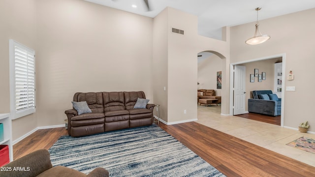 116 E Mountain Sky Ave, Phoenix, AZ 85048 - living area with arched walkways, a towering ceiling, and wood finished floors