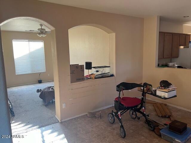 workout area featuring tile floors and ceiling fan