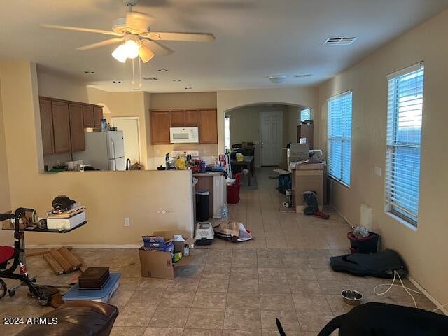 tiled living room featuring ceiling fan