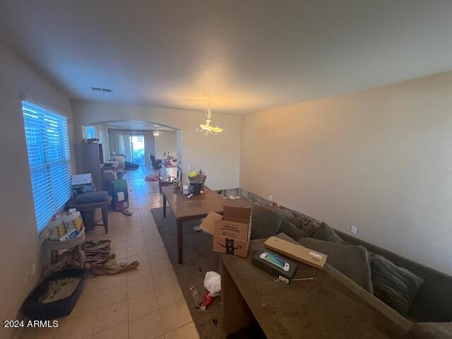 interior space with light tile flooring and a chandelier