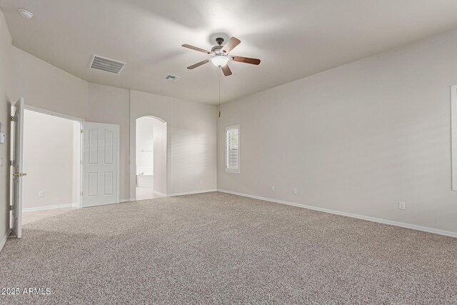 13007 W Tuckey Ct, Glendale, AZ 85307 - empty room featuring light carpet, a ceiling fan, arched walkways, and baseboards