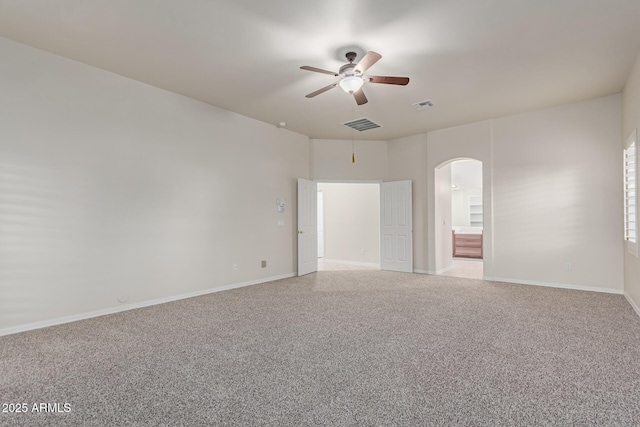 13007 W Tuckey Ct, Glendale, AZ 85307 - spare room featuring arched walkways, ceiling fan, carpet floors, and baseboards