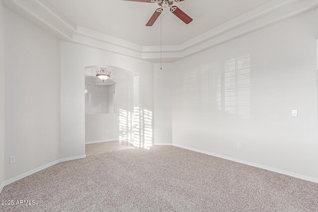 13007 W Tuckey Ct, Glendale, AZ 85307 - carpeted spare room with ceiling fan, a raised ceiling, arched walkways, and baseboards