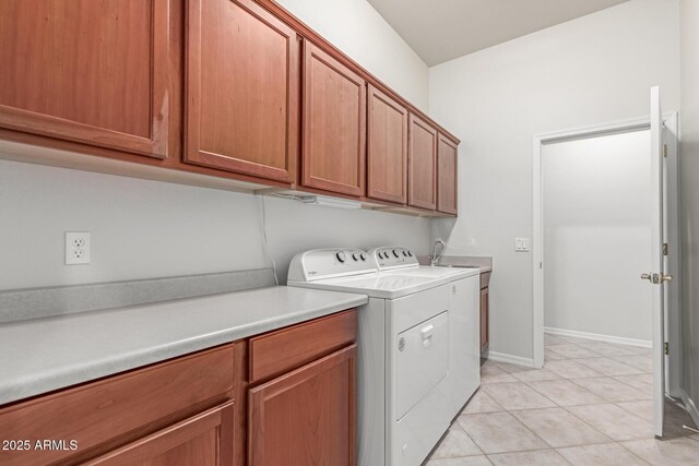13007 W Tuckey Ct, Glendale, AZ 85307 - washroom featuring cabinet space, washer and clothes dryer, light tile patterned floors, and baseboards
