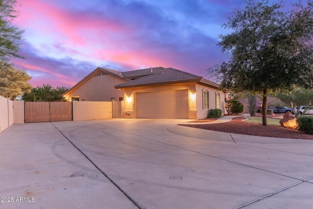 13007 W Tuckey Ct, Glendale, AZ 85307 - single story home with a gate, concrete driveway, an attached garage, stucco siding, and fence