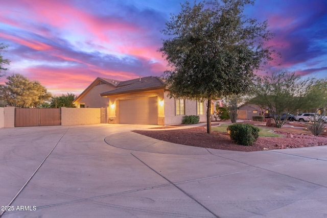 13007 W Tuckey Ct, Glendale, AZ 85307 - view of front of home with concrete driveway, a gate, stucco siding, an attached garage, and fence