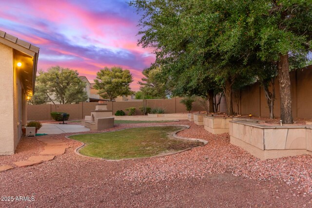13007 W Tuckey Ct, Glendale, AZ 85307 - yard at dusk with a fenced backyard and a patio area