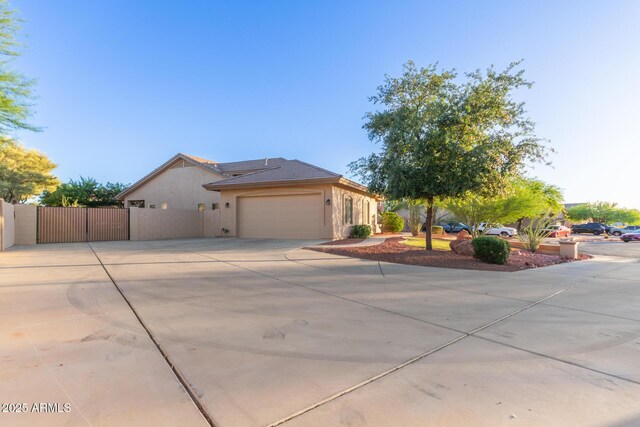 13007 W Tuckey Ct, Glendale, AZ 85307 - view of front of house with driveway, a garage, stucco siding, and fence