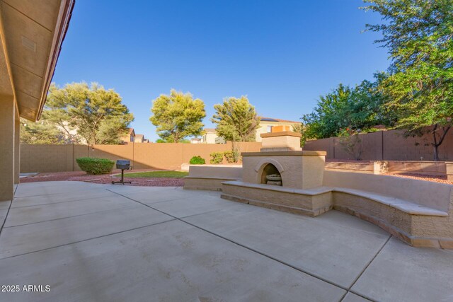 13007 W Tuckey Ct, Glendale, AZ 85307 - view of patio featuring exterior fireplace and a fenced backyard