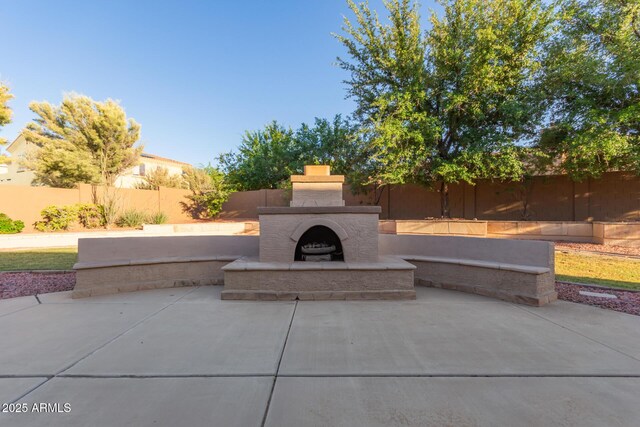 13007 W Tuckey Ct, Glendale, AZ 85307 - view of patio featuring an outdoor fireplace and a fenced backyard