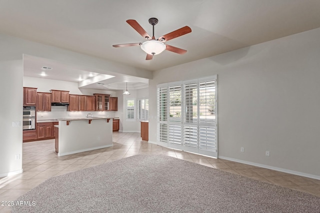 13007 W Tuckey Ct, Glendale, AZ 85307 - unfurnished living room featuring light tile patterned flooring, a ceiling fan, and baseboards