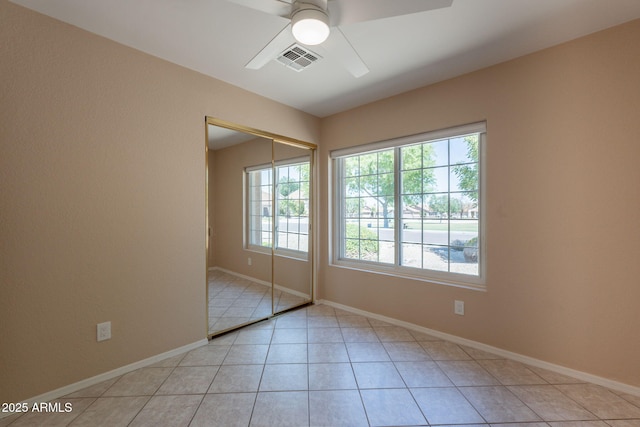 4349 W Cielo Grande, Glendale, AZ 85310 - unfurnished bedroom with light tile patterned floors, a closet, baseboards, and a ceiling fan