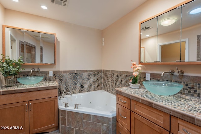4349 W Cielo Grande, Glendale, AZ 85310 - bathroom featuring a jetted tub, two vanities, and recessed lighting