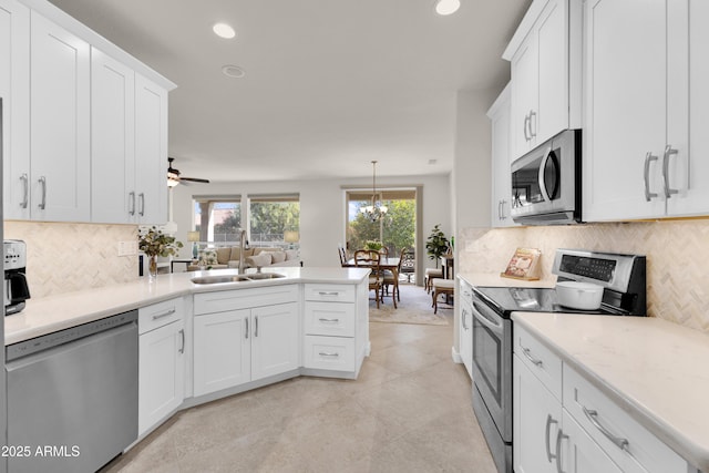 kitchen with white cabinetry, stainless steel appliances, and sink