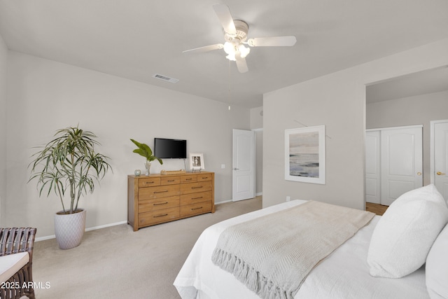 bedroom with ceiling fan and light carpet