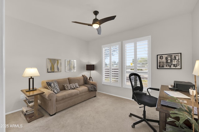 home office featuring light carpet and ceiling fan