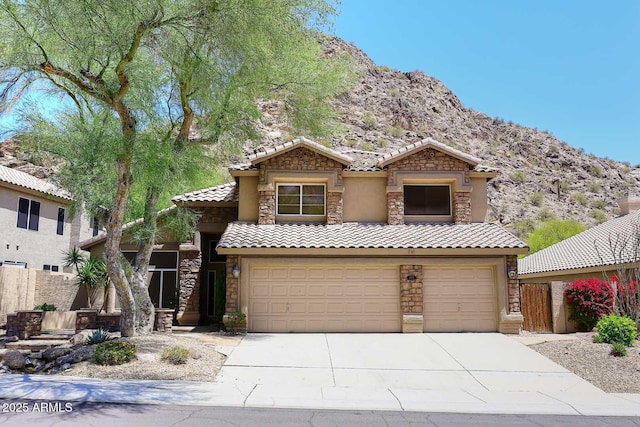 14833 S 14th Pl, Phoenix, AZ 85048 - traditional-style home with an attached garage, a tile roof, stone siding, a mountain view, and driveway
