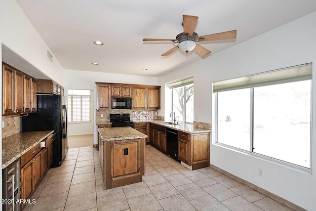14833 S 14th Pl, Phoenix, AZ 85048 - kitchen with decorative backsplash, a ceiling fan, a center island, a sink, and black appliances