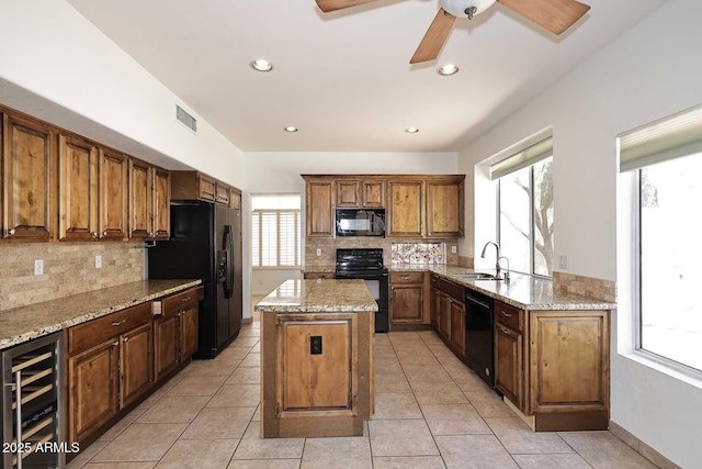14833 S 14th Pl, Phoenix, AZ 85048 - kitchen with visible vents, a center island, a sink, black appliances, and wine cooler