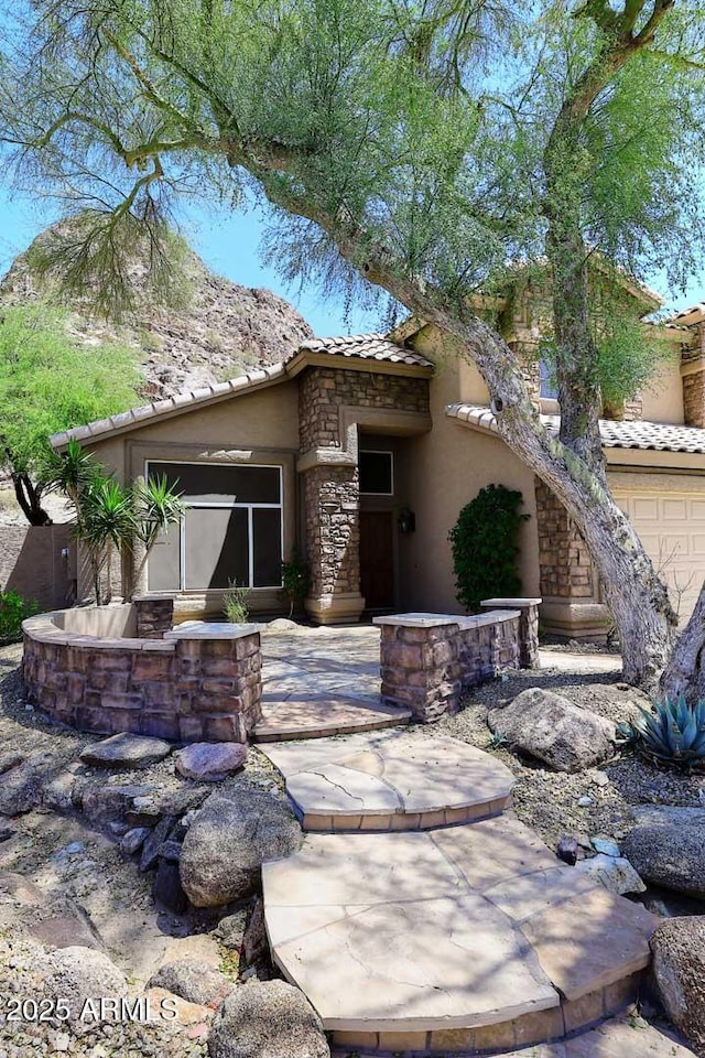 14833 S 14th Pl, Phoenix, AZ 85048 - back of property featuring stucco siding, a tile roof, and stone siding