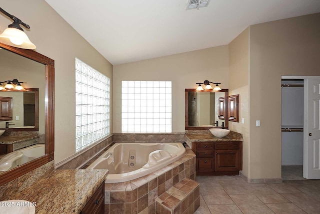 14833 S 14th Pl, Phoenix, AZ 85048 - bathroom with visible vents, vanity, lofted ceiling, a whirlpool tub, and tile patterned floors