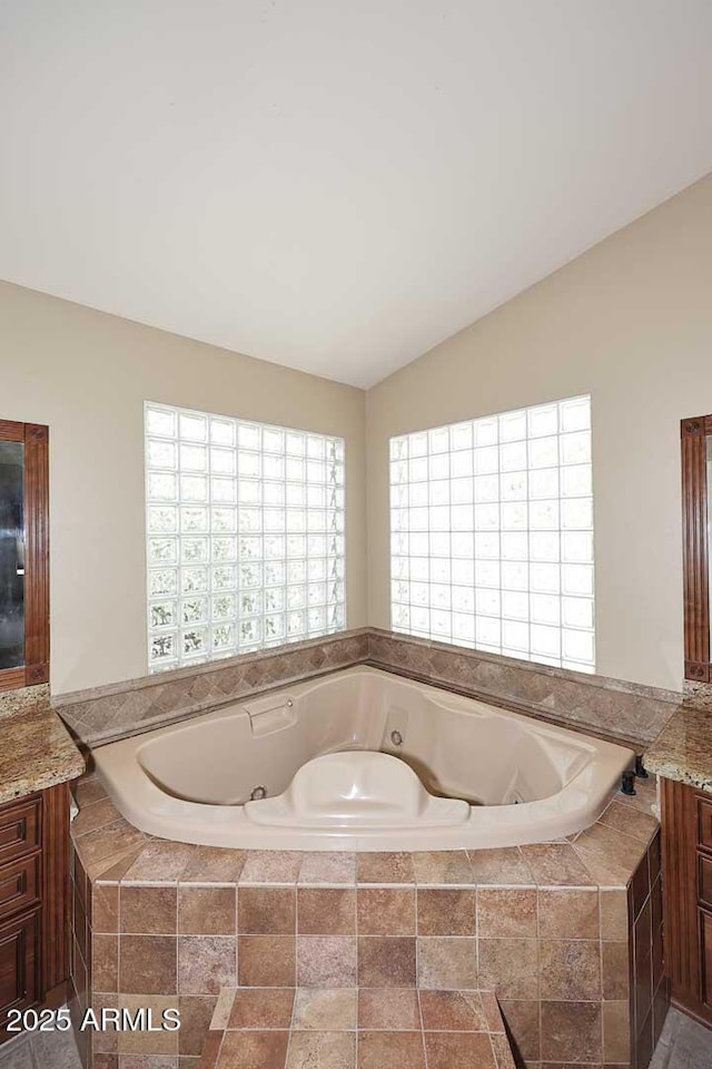 14833 S 14th Pl, Phoenix, AZ 85048 - full bathroom with vanity, lofted ceiling, and a tub with jets
