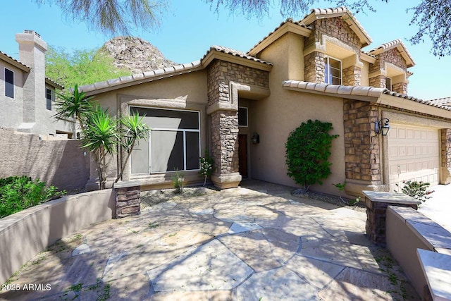 14833 S 14th Pl, Phoenix, AZ 85048 - mediterranean / spanish-style house with a patio, stucco siding, a tile roof, and stone siding