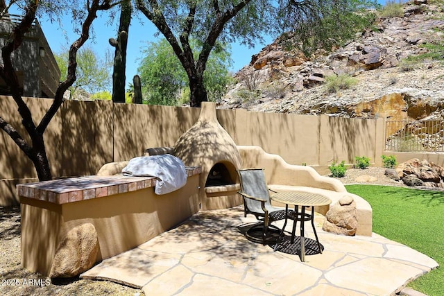 14833 S 14th Pl, Phoenix, AZ 85048 - view of patio with a fenced backyard and an outdoor kitchen