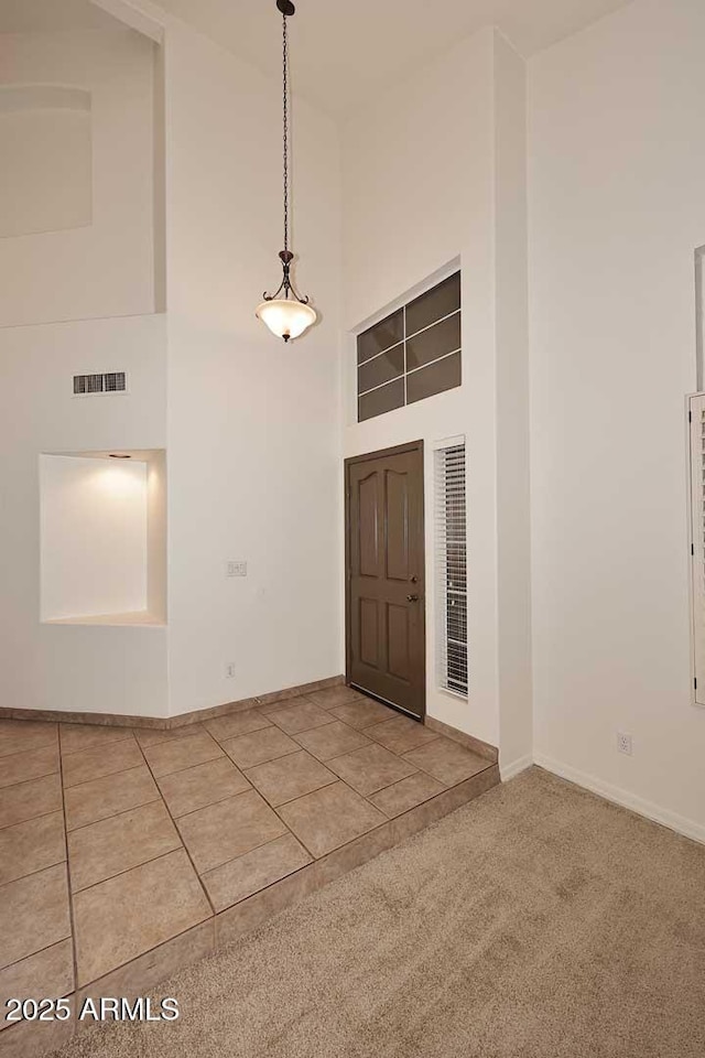 14833 S 14th Pl, Phoenix, AZ 85048 - carpeted entrance foyer featuring a high ceiling, visible vents, baseboards, and tile patterned floors
