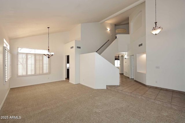 14833 S 14th Pl, Phoenix, AZ 85048 - unfurnished living room featuring visible vents, baseboards, high vaulted ceiling, carpet, and a notable chandelier