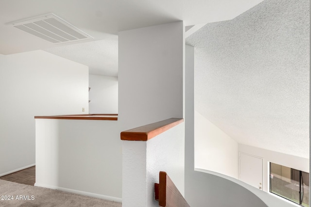 interior space featuring carpet flooring and a textured ceiling