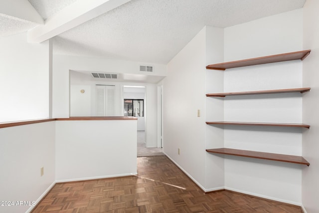 interior space with dark parquet flooring and a textured ceiling