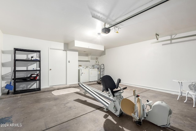 garage with a garage door opener and washing machine and clothes dryer