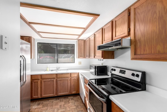 kitchen featuring appliances with stainless steel finishes, dark parquet floors, and sink