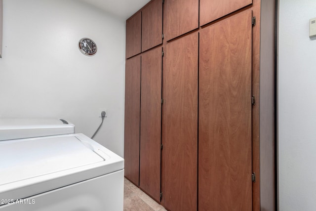 laundry room featuring washing machine and dryer and cabinets