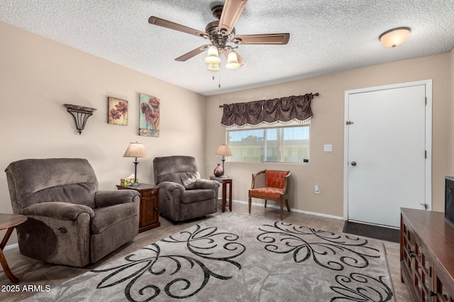 living room featuring a textured ceiling and ceiling fan