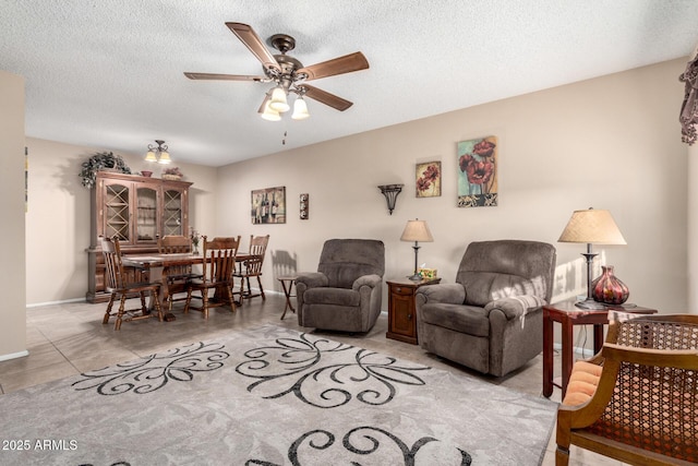 tiled living room featuring ceiling fan and a textured ceiling