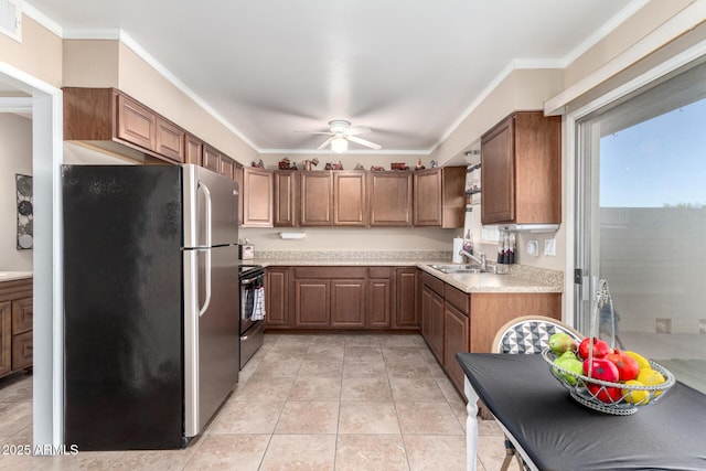 kitchen featuring ceiling fan, sink, appliances with stainless steel finishes, ornamental molding, and light tile patterned floors