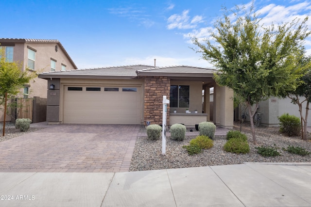 5871 N 187th Ln, Litchfield Park, AZ 85340 - view of front of property with decorative driveway, an attached garage, a tiled roof, and stucco siding