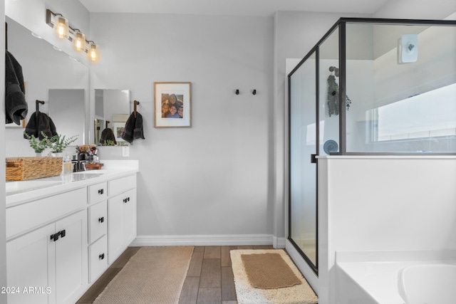 5871 N 187th Ln, Litchfield Park, AZ 85340 - full bathroom with a stall shower, vanity, wood finished floors, a bath, and baseboards